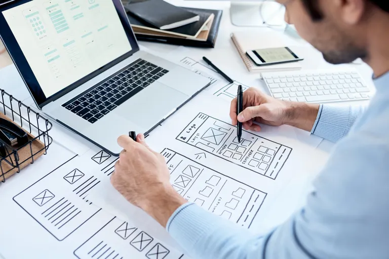 Designer working on website interface sketches